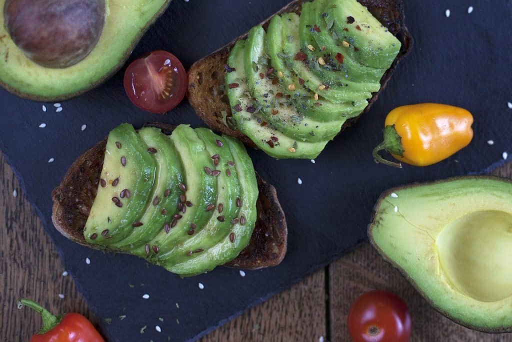 Avocado toast fanned on seeded bread