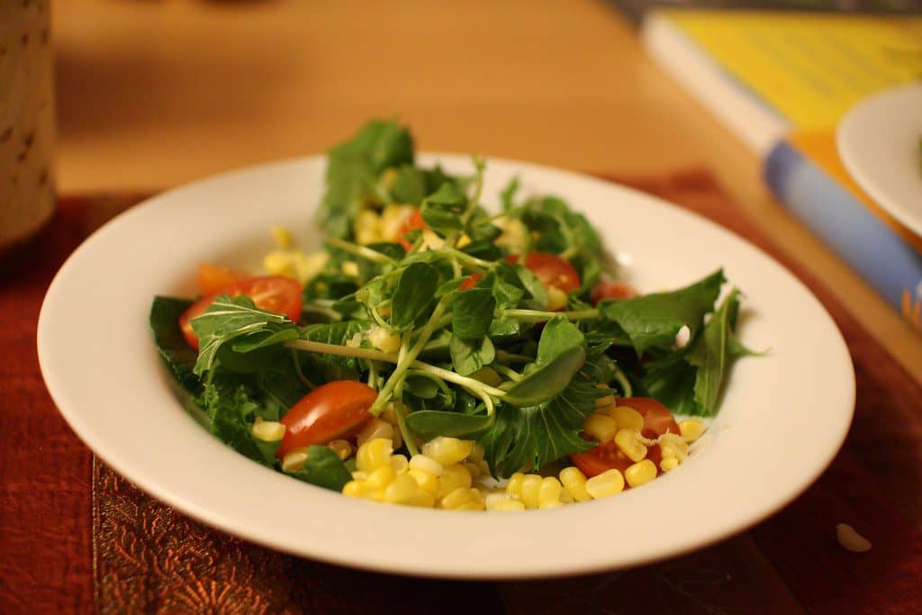 A bright salad bowl tossed with fresh greens
